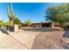 Southwestern-style home boasting desert landscaping, an attached carport, and a prominent saguaro cactus at 12423 N 64Th St, Scottsdale, AZ 85254