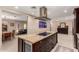 Open-concept kitchen with a large island, stainless steel appliances, marble countertops, and dining area access at 12423 N 64Th St, Scottsdale, AZ 85254