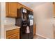 Kitchen featuring a black refrigerator with water dispenser, complemented by wood cabinets at 12423 N 64Th St, Scottsdale, AZ 85254