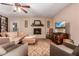 Cozy living room with a classic brick fireplace and comfortable seating arrangement at 12423 N 64Th St, Scottsdale, AZ 85254