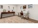 Charming home office with multiple windows, desk, console table, and stylish rug at 12423 N 64Th St, Scottsdale, AZ 85254