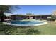 Relaxing backyard pool with grassy yard, perfect for summertime fun and entertaining guests outdoors at 12423 N 64Th St, Scottsdale, AZ 85254