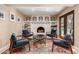 Bright and inviting sitting area features a fireplace with stylish furniture at 12423 N 64Th St, Scottsdale, AZ 85254
