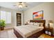 Inviting bedroom with wooden floors, an open closet, and stylish furniture, lit by natural light and lamps at 1342 W Emerald Ave # 286, Mesa, AZ 85202