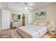 Serene bedroom with a plush rug, stylish furniture, modern fan, and art pieces that accent the wall space at 1342 W Emerald Ave # 286, Mesa, AZ 85202