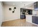 Dining area showcasing neutral walls, contemporary lighting, and views of the open-concept kitchen with updated appliances at 1342 W Emerald Ave # 286, Mesa, AZ 85202