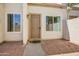 Welcoming front porch with a brown metal door, brick flooring, and neutral-toned walls, creating a cozy entrance at 1342 W Emerald Ave # 286, Mesa, AZ 85202