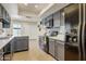 Contemporary kitchen featuring gray cabinets, black appliances, and a bright, airy ambiance with views of the patio at 1342 W Emerald Ave # 286, Mesa, AZ 85202