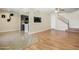 Spacious living area with tile and hardwood floors with a kitchen pass-through and open staircase at 1342 W Emerald Ave # 286, Mesa, AZ 85202