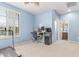 Bedroom with large window, desk and computer setup; bathroom visible in the background at 1547 W Lacewood W Pl, Phoenix, AZ 85045
