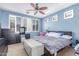 Comfortable bedroom featuring carpet, a ceiling fan, and blue walls at 1547 W Lacewood W Pl, Phoenix, AZ 85045