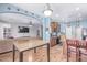 Open-concept kitchen flows into the dining area, featuring wood cabinets and updated appliances at 1547 W Lacewood W Pl, Phoenix, AZ 85045