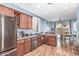 This kitchen features wooden cabinets, stainless steel appliances, and hardwood floors at 1547 W Lacewood W Pl, Phoenix, AZ 85045