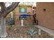 Home exterior featuring desert landscaping and a statue, shaded by a beautiful tree at 16233 E Rosetta Dr # 47, Fountain Hills, AZ 85268