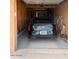 A black car is parked inside a single car garage with wooden framing visible near the ceiling at 16233 E Rosetta Dr # 47, Fountain Hills, AZ 85268