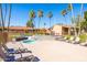 Relaxing community hot tub with lounge chairs and palm trees under a clear blue sky at 16233 E Rosetta Dr # 47, Fountain Hills, AZ 85268