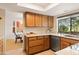 Bright kitchen with window views featuring wood cabinets and stone countertops at 16233 E Rosetta Dr # 47, Fountain Hills, AZ 85268