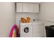 Bright laundry room featuring a washer, dryer, and ample storage cabinets at 16233 E Rosetta Dr # 47, Fountain Hills, AZ 85268