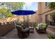 Inviting outdoor patio with comfortable seating beneath a large blue umbrella, perfect for relaxing at 16233 E Rosetta Dr # 47, Fountain Hills, AZ 85268
