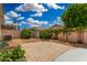Spacious backyard with a brick patio, desert landscaping, and block wall fencing for privacy at 1653 E Gail Dr, Chandler, AZ 85225
