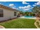 Enjoy the lush backyard featuring artificial turf, a sparkling pool, and a cozy covered patio for outdoor living at 1653 E Gail Dr, Chandler, AZ 85225