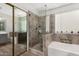 Modern bathroom featuring glass shower and separate soaking tub at 1653 E Gail Dr, Chandler, AZ 85225