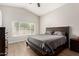 Spacious bedroom features a large bed, wood floors, and ample natural light at 1653 E Gail Dr, Chandler, AZ 85225
