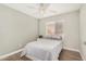 Bright bedroom with light-colored walls, ceiling fan, and comfortable bed at 1653 E Gail Dr, Chandler, AZ 85225