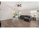 Open living area with grey sofa, wood-look floors, and sliding glass doors to a pool at 1653 E Gail Dr, Chandler, AZ 85225