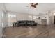 Open living area with grey sofa, wood-look floors, and view of the kitchen at 1653 E Gail Dr, Chandler, AZ 85225