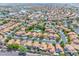 Aerial view of a vibrant neighborhood with orange tile roofs and verdant trees surrounding the homes at 16622 S 32Nd Pl, Phoenix, AZ 85048