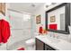 Elegant bathroom with a glass-enclosed shower, vanity, modern sink and decorative mirror at 16622 S 32Nd Pl, Phoenix, AZ 85048
