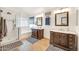 Bright bathroom featuring a glass-enclosed shower and a double vanity with marble countertops at 16622 S 32Nd Pl, Phoenix, AZ 85048