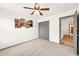 Bright, unfurnished bedroom with neutral carpet, a ceiling fan, and a closet at 16622 S 32Nd Pl, Phoenix, AZ 85048