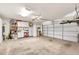 Spacious garage featuring ample storage cabinets and a white paneled garage door at 16622 S 32Nd Pl, Phoenix, AZ 85048