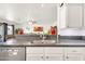Bright kitchen showcasing a stainless steel sink, gray countertops, and white cabinets at 16622 S 32Nd Pl, Phoenix, AZ 85048