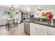 Bright kitchen featuring an island with seating, stainless steel dishwasher and gray countertops at 16622 S 32Nd Pl, Phoenix, AZ 85048