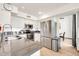 Well-lit kitchen boasts stainless steel appliances, white cabinets, and sleek countertops for a modern cooking experience at 16622 S 32Nd Pl, Phoenix, AZ 85048