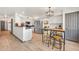 Open kitchen with stainless steel appliances, white cabinetry, and an island with barstool seating at 16622 S 32Nd Pl, Phoenix, AZ 85048