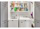 Well-equipped laundry room with a modern washer, dryer and ample shelving at 16622 S 32Nd Pl, Phoenix, AZ 85048