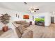 Inviting living room featuring a comfortable sectional sofa, fan and a mounted television at 16622 S 32Nd Pl, Phoenix, AZ 85048