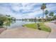 Picturesque waterfront scene with a boat launch, lush greenery, and beautiful homes in the background at 16622 S 32Nd Pl, Phoenix, AZ 85048