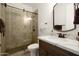 Well-lit bathroom featuring a walk-in shower with a rainfall showerhead, a toilet, a vanity, and decoratively hung towels at 17665 N 93Rd Way, Scottsdale, AZ 85255