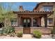 Charming front entrance with stone accents, wooden beams, and a cozy patio at 17665 N 93Rd Way, Scottsdale, AZ 85255