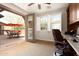 Cozy home office with patio access, built-in shelves, and a comfortable workspace at 17665 N 93Rd Way, Scottsdale, AZ 85255