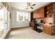 Well-lit home office with built-in desk, shelves, and bright windows at 17665 N 93Rd Way, Scottsdale, AZ 85255