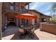 Outdoor patio area featuring a dining set with an umbrella and stone accents at 17665 N 93Rd Way, Scottsdale, AZ 85255