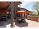 Wonderful patio with dining set and orange umbrella, perfect for outdoor entertaining at 17665 N 93Rd Way, Scottsdale, AZ 85255