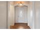 Inviting entryway featuring a decorative light fixture and elegant front door with an oval glass insert at 18222 W Lundberg St, Surprise, AZ 85388