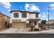 Charming two-story home featuring a two-car garage, landscaped yard, and solar panels for energy efficiency at 18222 W Lundberg St, Surprise, AZ 85388